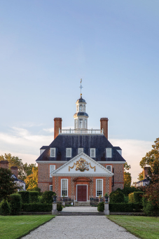 colonial american building with a gravel walkway leading to it