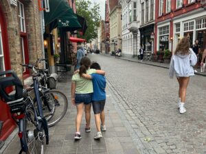 two children walking down a european street