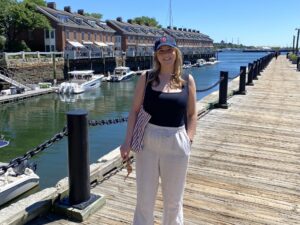 woman standing on dock by the water