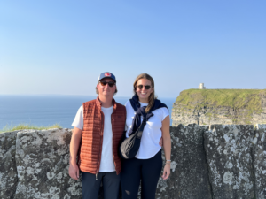 couple standing by a stone wall